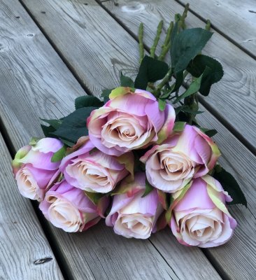 Vacker lila/rosa ros med gröna blad. Välarbetad vacker konstgjord ros med hög verklighets trogen känsla. Lika vacker ensam som i