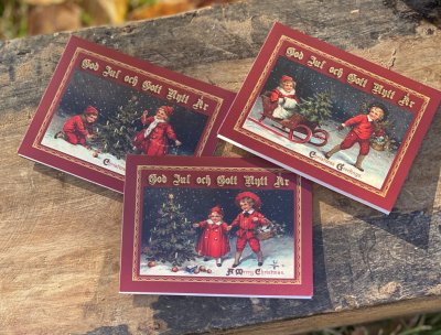 Julkort med gammeldags motiv av barn i julbestyr. I pack om 12st dubbla kort med kuvert. Att sätta på paket eller skicka hälsnin