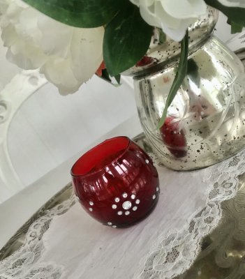 Röd ljuslykta/ljusglas i  glas . Rundad i modellen dekorerad runt om med strass stenar  och ristat dekor i ett fint mönster. Mör