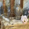 Vaser / flaskor i glas som står i en nätad rost brun korg med ring formade handtag. Till blommor , förvaring eller dekoration.