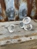 Rund knopp i glas med diskret mönster runt om