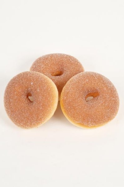 Nybakt munk donuts med socker täcke, att dekorera med. Konstgjord och välgjord med hög verklighetskänsla. I ett mjuk skum konst