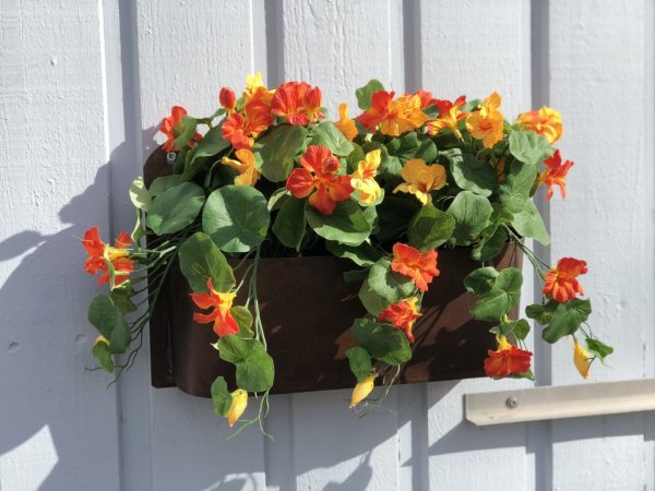 Vacker krasse konstblomma/ växt med blommor och gröna blad. Står i en plastad innerkruka som med fördel kan ställas i en större