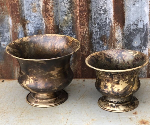 Vacker antik kruka/urna på fot i skål modell. Går i en ruffig nyans av antik guld. Finns i två storlekar. -Högre -Lägre Tillverk