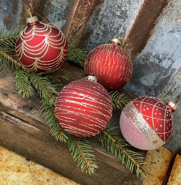 Julgranskulor / glaskulor i rött med vackra guld glittrande mönster inslag. I pack om 4st kulor med olika mönster . Eleganta med