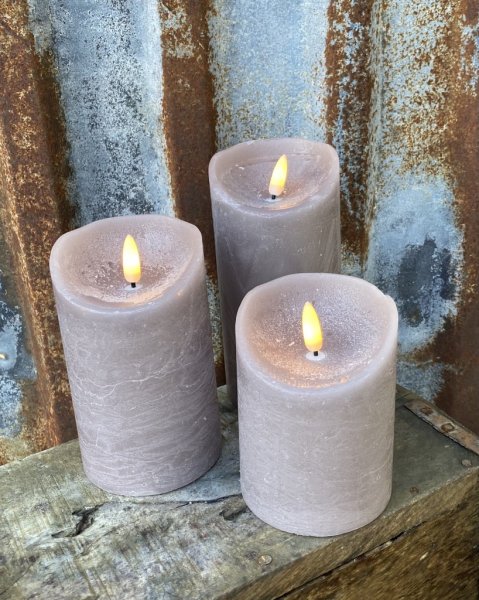 Brun/ beiga cylinderformade ljus/led ljus , riktigt vaxljus därav skiftande i mörka och ljusa nyanser. Batteri drivna med timer