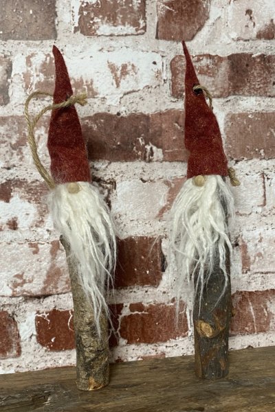 Hängande tomte med röd luva och vitt skägg. Skogs tomte med kropp av trä. Varje romte är unik och ingen är den andre lik. Rolig