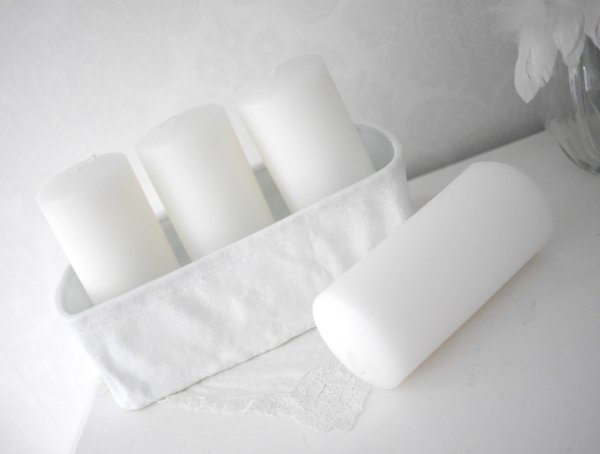 Vit keramik form i levande modell. Utformad som en stel säck med struktur yta. Avlång i formen passande att ha cylinder ljus i n