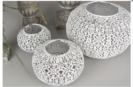 Orientalisk vit ljuslykta format som en boll i lätt oval modell. Med vackert mönster runt om. Tillverkad i plåt med fabriks nött